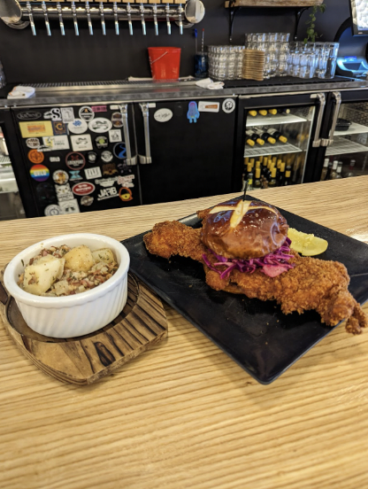 Chicken Schnitzel sandwich special with potato salad 		
